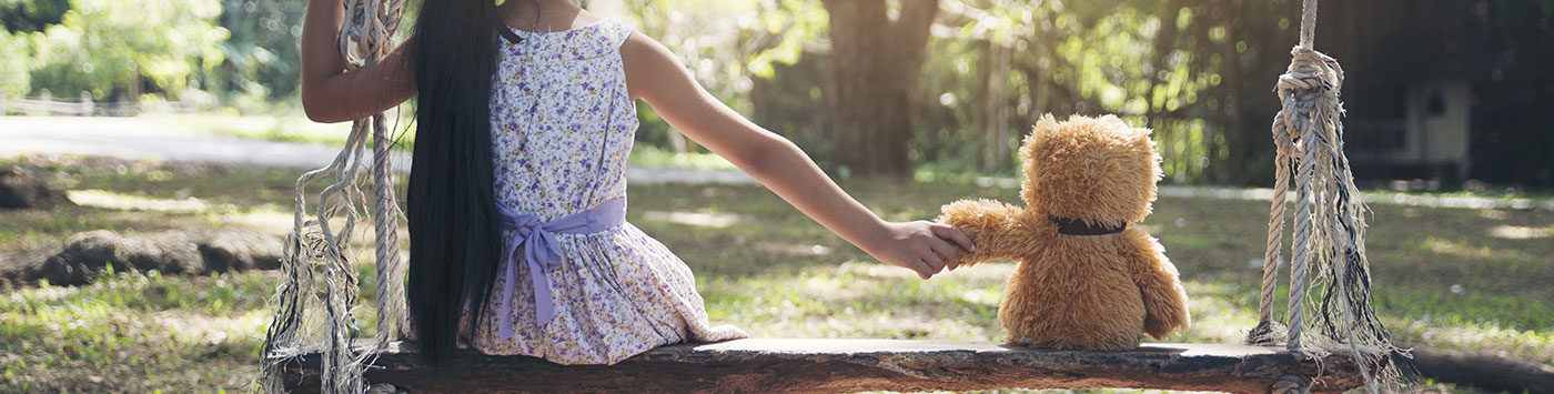 Child On Swing With Teddy Bear