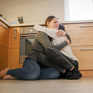 Young Woman Hugging Upset Crying Teenager Crisis Hotline