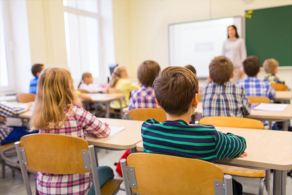 Kids Inclassroom Listening To Teacher