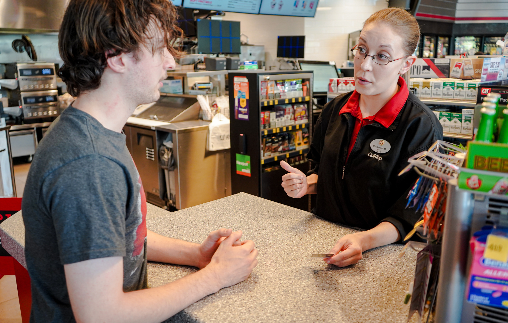 A young person is assisted by an employee at a Safe Place partner location.
