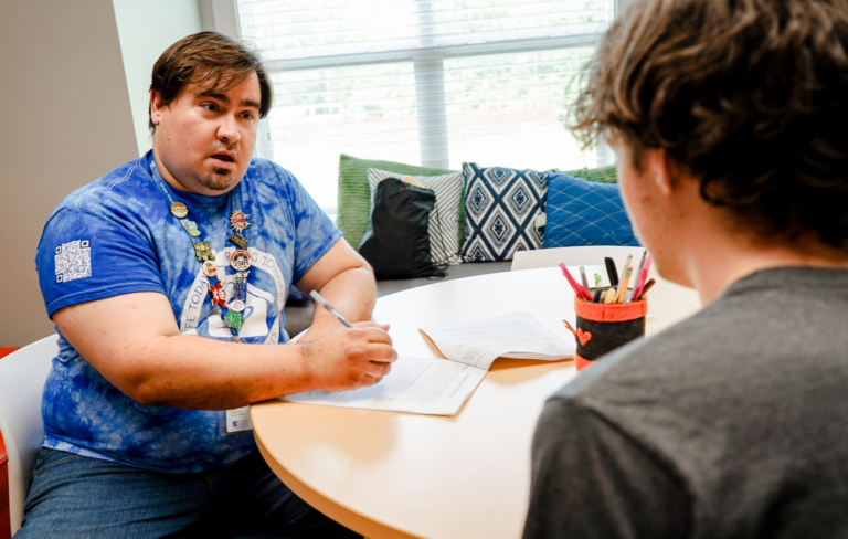 A member of the Synergy Services team connects a youth to resources and assistance.
