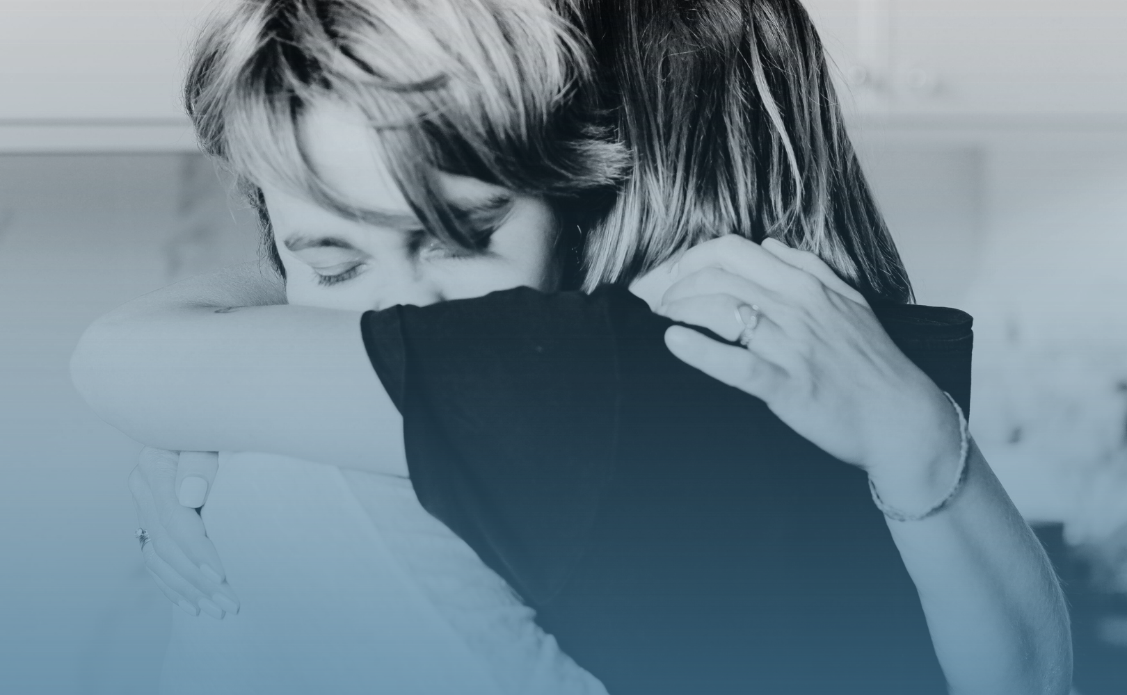 friends hugging in a supportive way